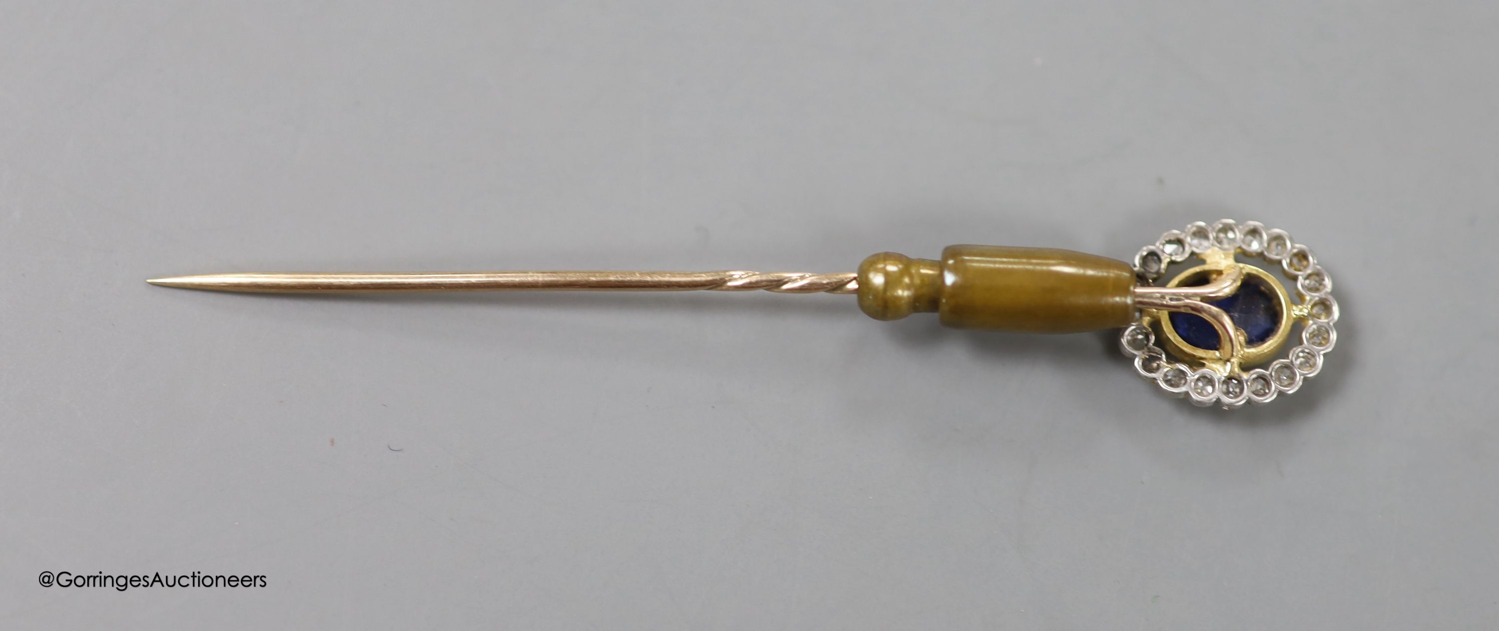 An early 20th century yellow metal, sapphire and diamond set oval cluster stick pin, 72mm, gross weight 3.9 grams